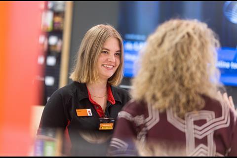 Staff member smiling at customer at Sainsbury’s Cobham store